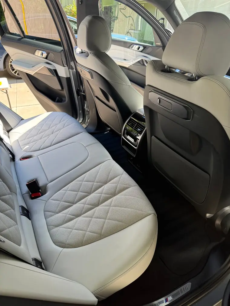 Grey BMW X5 white leather rear seats and clean floor after a mobile interior detail by A&F Auto Detailing in Oakland Township, MI