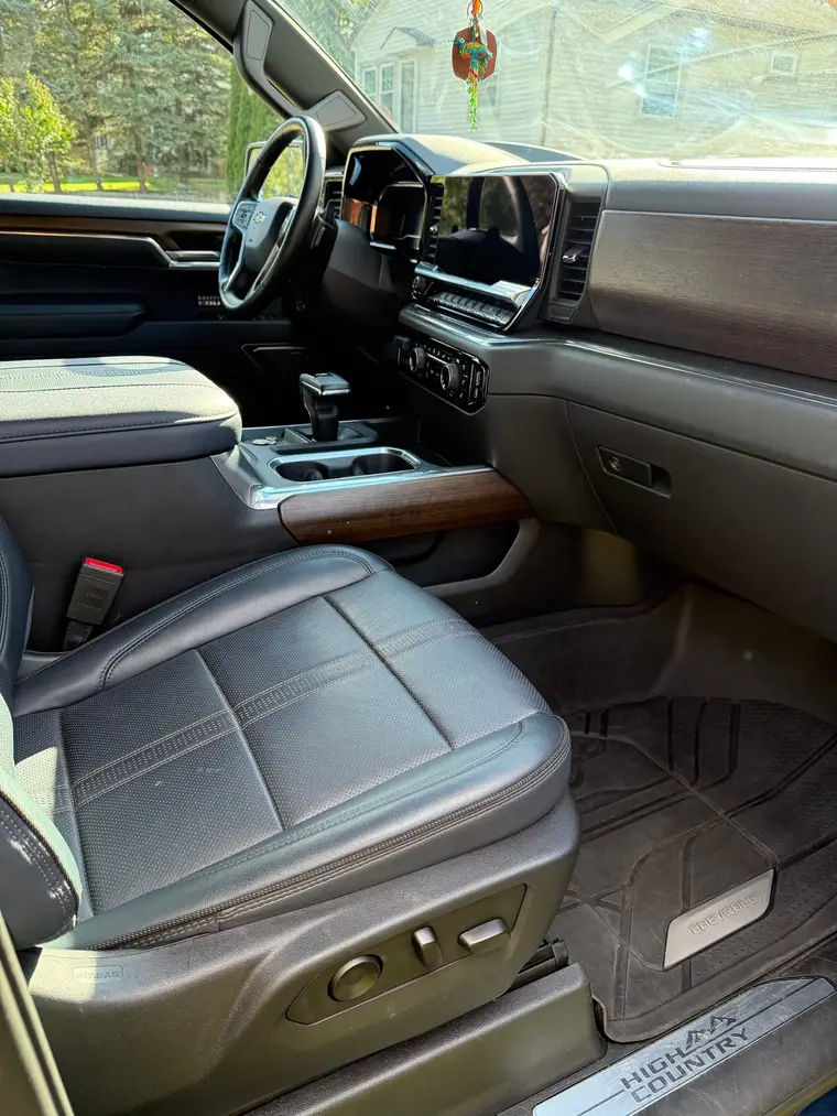 Dark blue Chevrolet Silverado High Country passenger seat and clean floor mat after a mobile interior detail by A&F Auto Detailing in Rochester Hills, MI
